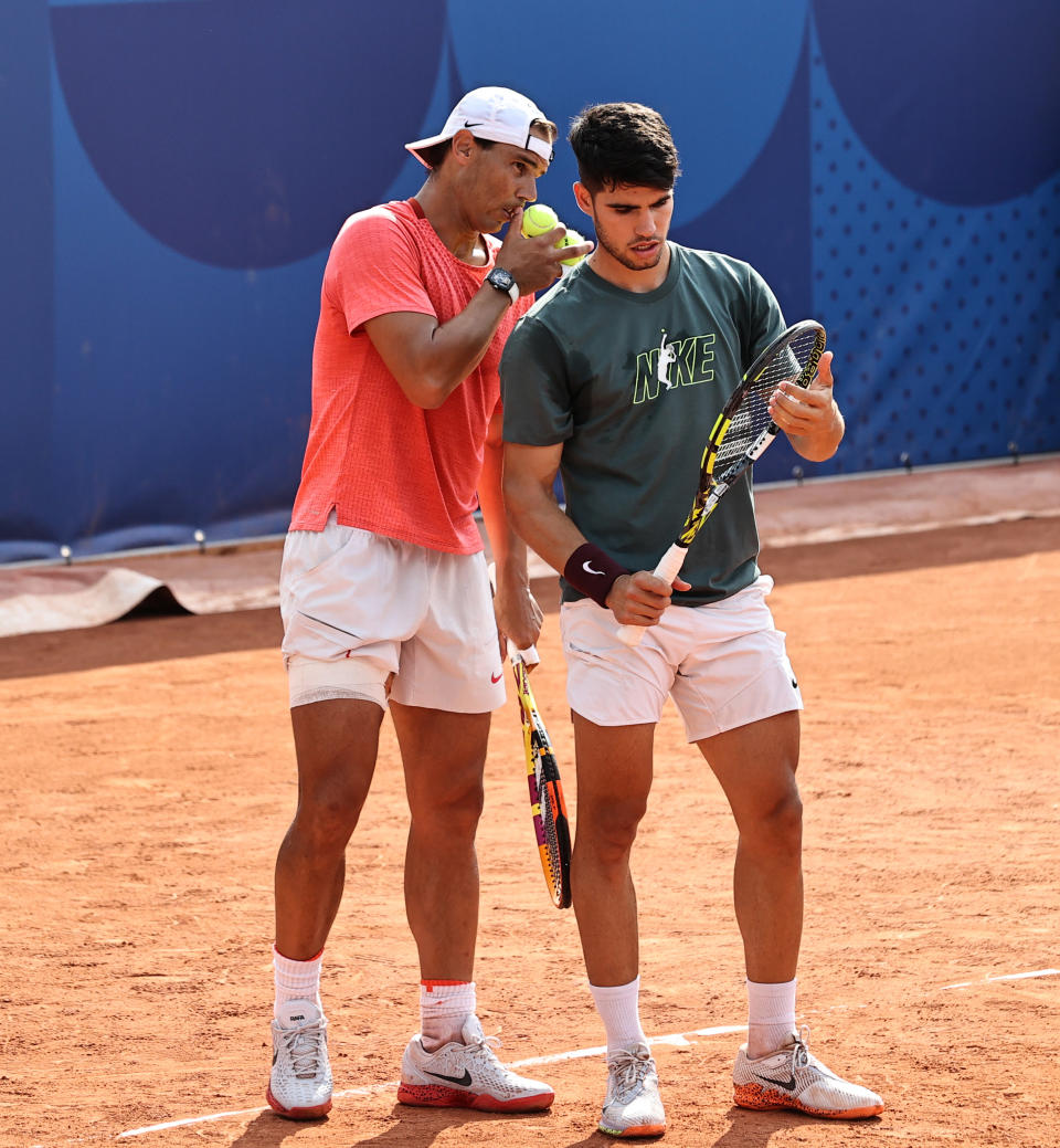 Carlos Alcaraz and Rafael Nadal practice.