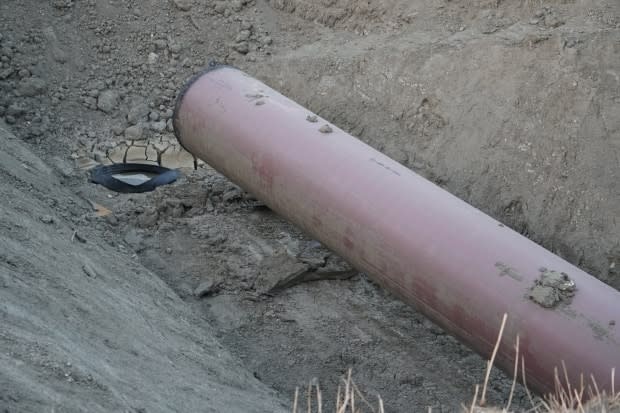 A section of pipe is placed in a trench near Oyen, Alta., as part of the Keystone XL project in September 2020. The Alberta government and TC Energy announced the official termination of the pipeline extension on Wednesday. (Kyle Bakx/CBC - image credit)