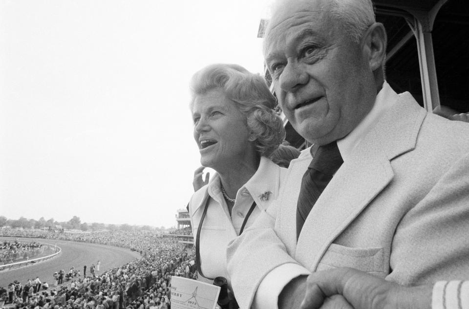 Owner of Secretariat, Penny Chenery (left) and trainer Lucien Laurin (right) intently watch their horse run the 99th Kentucky Derby at Churchill Downs. 