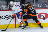 Philadelphia Flyers' Wade Allison (57) collides with New York Islanders' Adam Pelech (3) during the third period of an NHL hockey game, Sunday, April 18, 2021, in Philadelphia. (AP Photo/Matt Slocum)