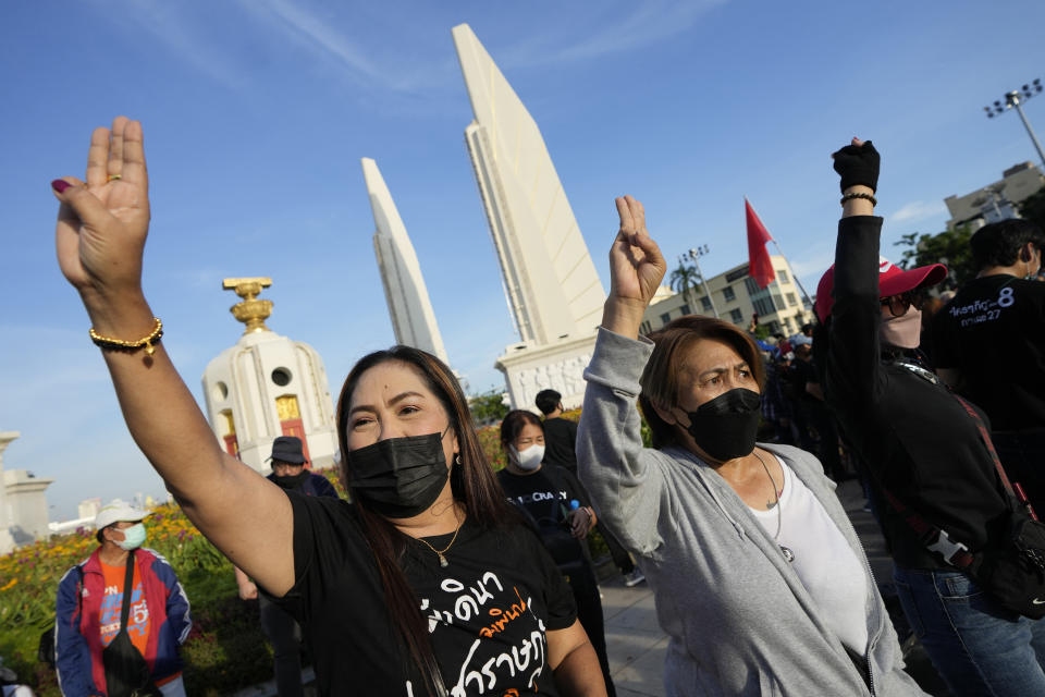 Anti-government protesters shout "Prayuth get out" as they gather in front of Democracy Monument to demand that Prime Minister Prayuth Chan-ocha step down from his position in Bangkok, Thailand Tuesday, Aug. 23, 2022. Thailand Constitutional Court on Monday received a petition from opposition lawmakers seeking a ruling on whether Prayuth has reached the legal limit on how long he can remain in office. (AP Photo/Sakchai Lalit)