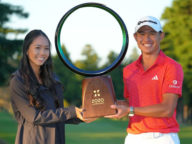 <p>Yoshimasa Nakano/Getty</p> Collin Morikawa with his wife Katherine Zhu after winning the tournament during the final round of ZOZO Championship on October 22, 2023 in Inzai, Chiba, Japan.