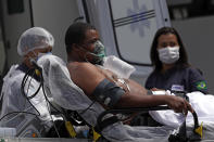 A 41-year-old patient suspected of having COVID-19 arrives from an ambulance to the HRAN public hospital in Brasilia, Brazil, Wednesday, April 14, 2021. (AP Photo/Eraldo Peres)