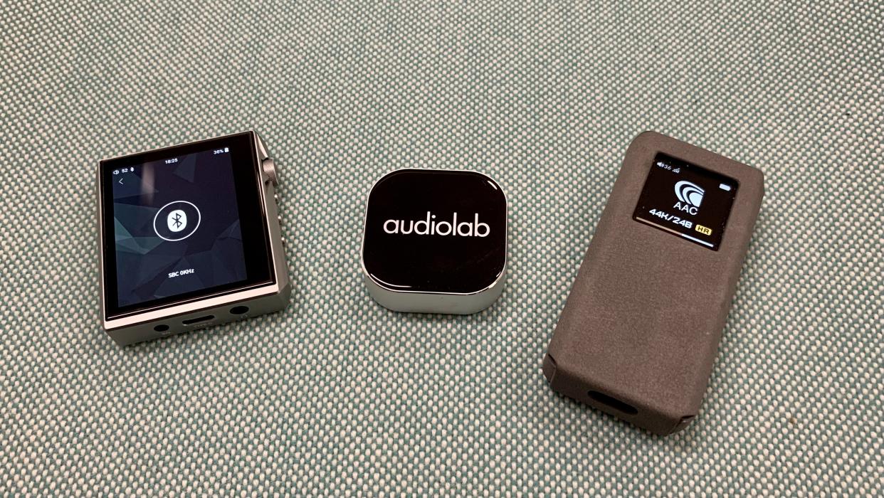  FiiO BTR7, Audiolab M-DAC Nano and Hidizs AP80 Pro-X side by side on blue background 