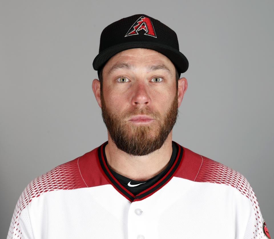 Greg Holland of the Arizona Diamondbacks baseball team poses Wednesday, Feb. 20, 2019, in Scottsdale, Ariz. While Manny Machado agreed to a pending $300 million, 10-year contract with San Diego and Bryce Harper is likely to top Giancarlo Stanton's record $325 million, 13-year deal, many less-than-superstar veterans have been routed on the free-agent market. Holland was cut from $14 million to $2 million this season. (AP Photo//Matt York)