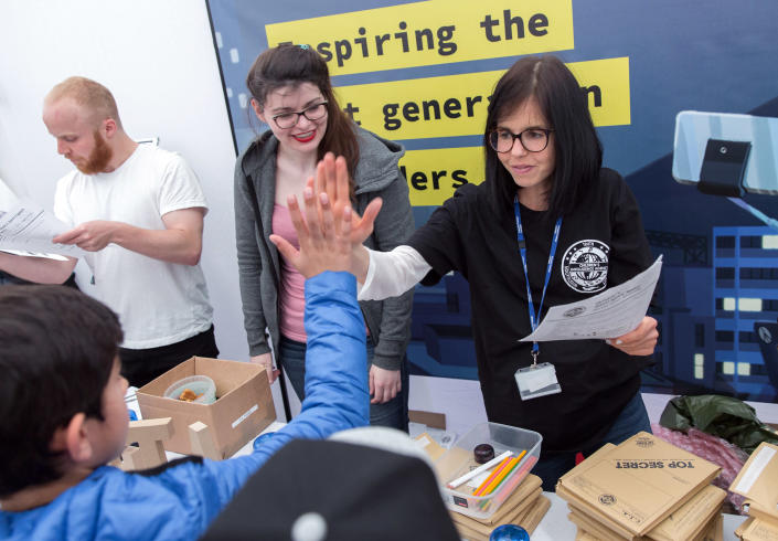 Jessica Wade high-fives an audience member at a presentation. (Courtesy Jess Wade)