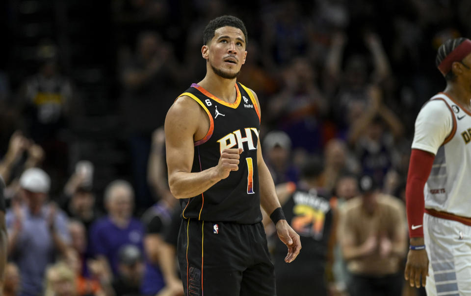 PHOENIX, AZ - MAY 5: Devin Booker (1) of the Phoenix Suns pumps his fist after Kevin Durant (35) made a shot, while being fouled during the second quarter against the Denver Nuggets at Footprint Center in Phoenix on Friday, May 5, 2023. (Photo by AAron Ontiveroz/MediaNews Group/The Denver Post via Getty Images)