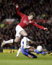 FILE - In this Saturday Jan. 27, 2007 file photo Manchester United's Ole Gunnar Solskjaer, left, has a shot on goal past Portsmouth's Sol Campbell during their FA Cup fourth round soccer match at Old Trafford Stadium, Manchester, England. Manchester United announced Wednesday Dec. 19, 2018, they have hired Ole Gunnar Solskjaer as its manager until the end of the season, bringing the Norwegian back to the club 20 seasons after he scored its winning goal in the Champions League final. (AP Photo/Scott Heppell, File)