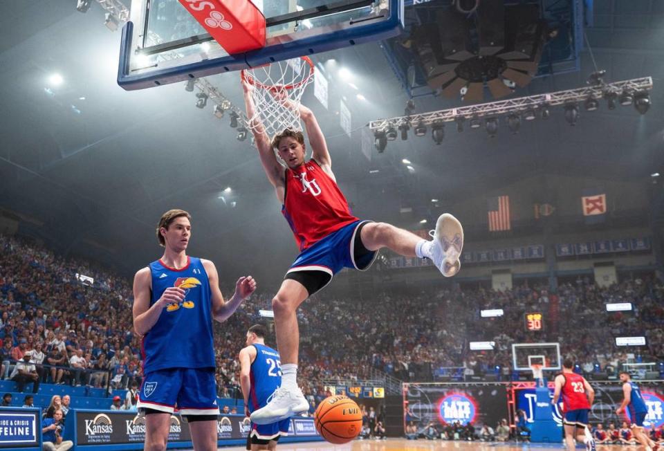 Johnny Furphy hangs from the rim after dunking during Late Night in the Phog on Friday, Oct. 6, 2023, at Allen Fieldhouse in Lawrence. Zachary Linhares/zlinhares@kcstar.com