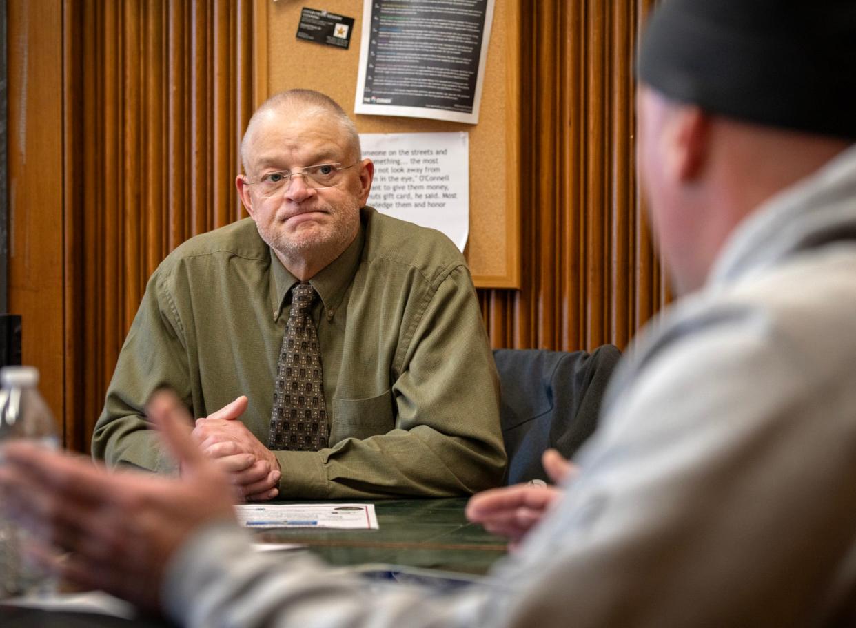 Stephen Curry, Fitchburg public health director, meets with street outreach worker Keith Barnaby, right, Tuesday.