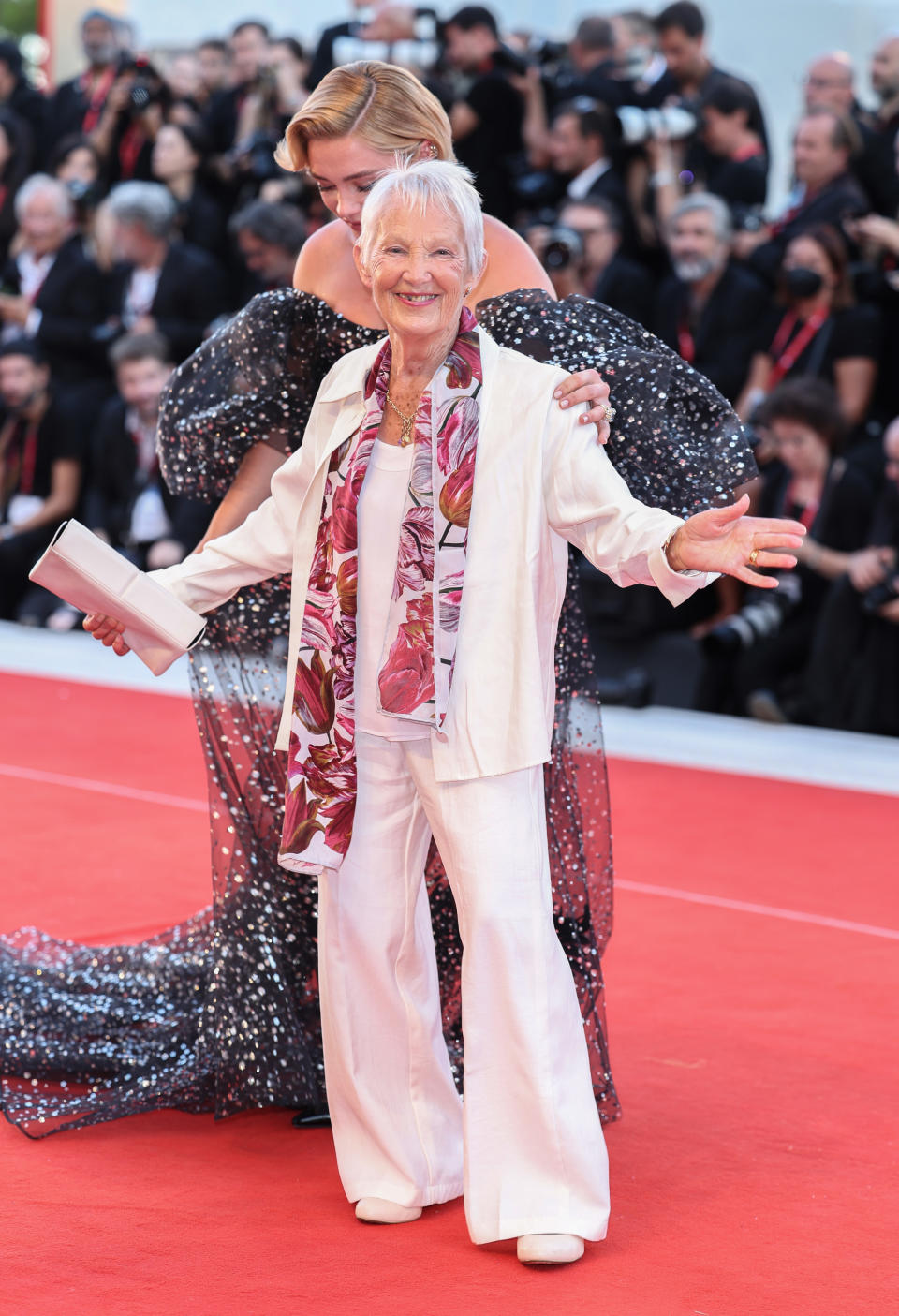 Florence's grandma holds her arms out and smiles