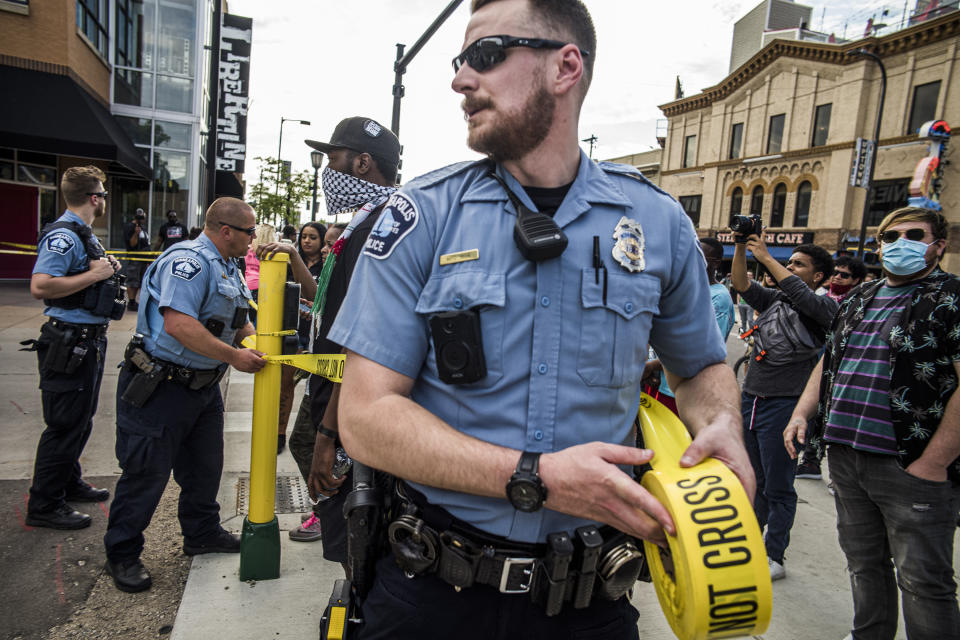 Police investigate a shooting as protesters gather on Thursday, June 3, 2021 in Minneapolis. Crowds vandalized buildings and stole from businesses in Minneapolis’ Uptown neighborhood after officials said a man wanted for illegally possessing a gun was fatally shot by authorities. (Richard.Tsong-Taatari/Star Tribune via AP)