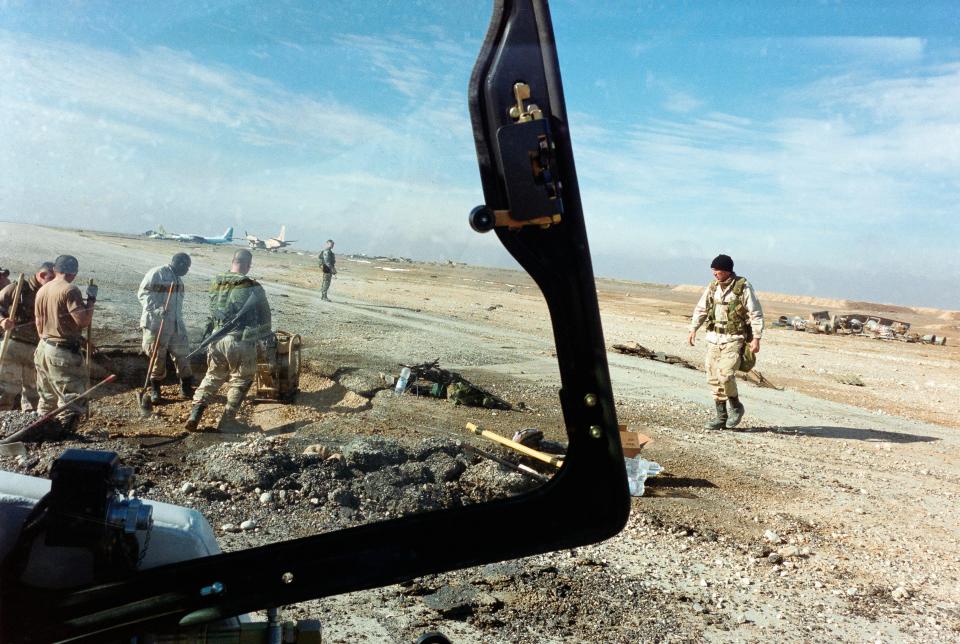 Soldiers are seen repairing an airfield