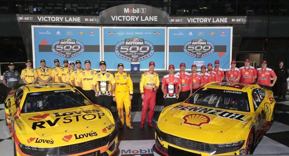 Michael McDowell and Joey Logano and crews in celebrate in victory lane after the drivers secured the front row for the 2024 Daytona 500.