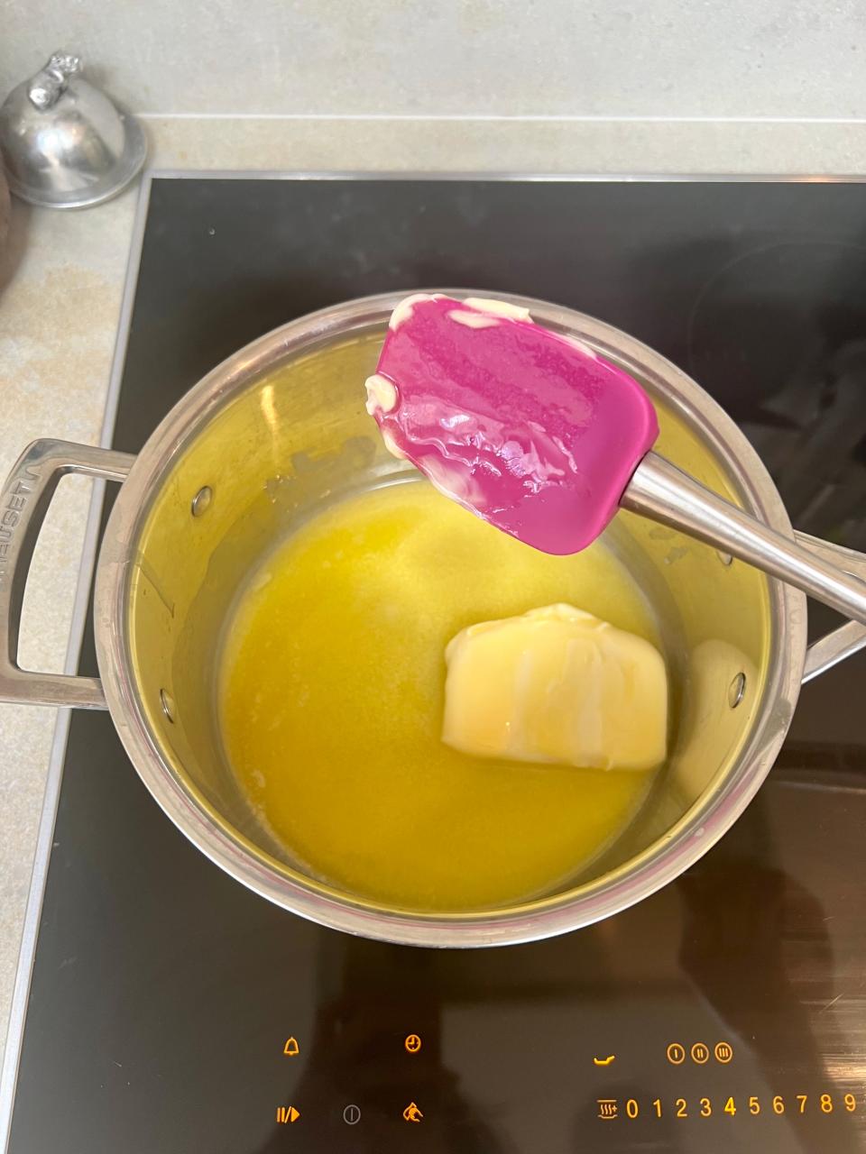 A saucepan of melted butter on the stovetop.