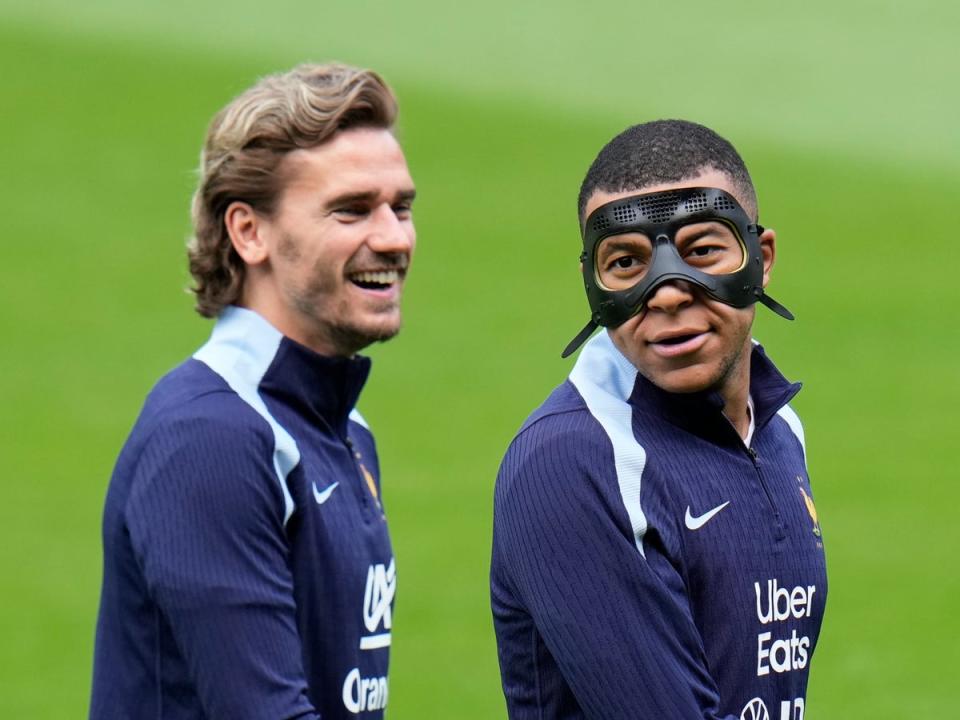 France's Kylian Mbappe gestures next to his teammate Antoine Griezmann during a training session (AP)