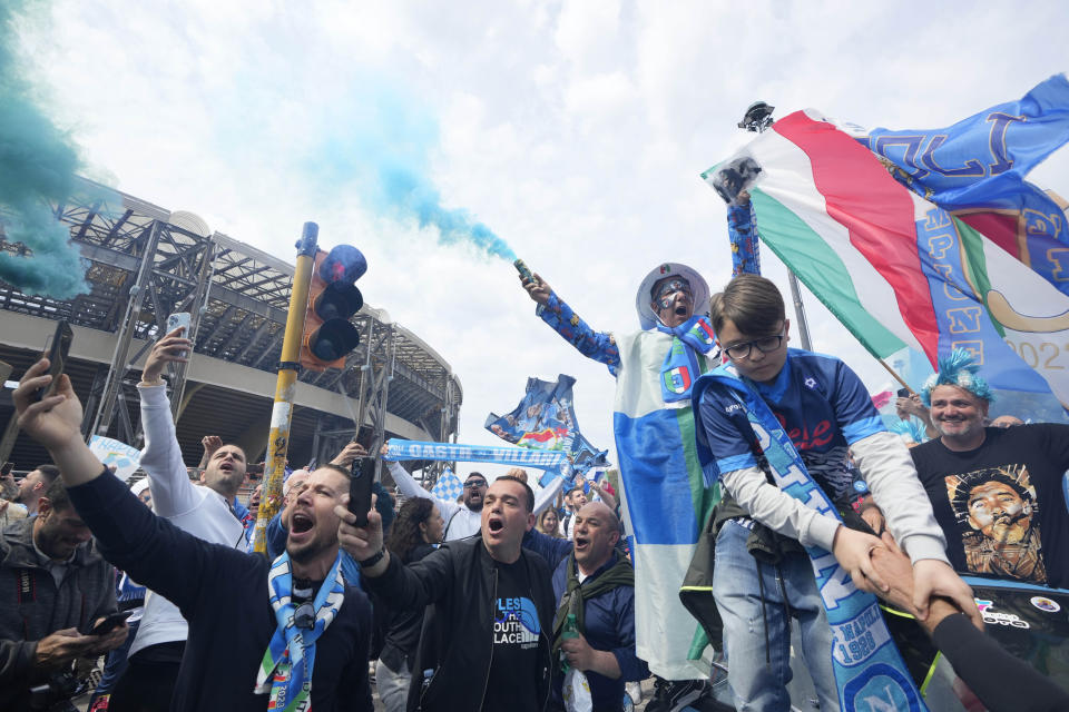 Napoli fans celebrate outside the Diego Maradona stadium in Naples, Italy, Sunday, April 30, 2023. After Napoli's game was moved to Sunday, the team could secure the title in front of their own fans by beating Salernitana — if Lazio fails to win at Inter Milan earlier in the day. Diego Maradona led Napoli to its only previous Serie A titles in 1987 and 1990. (AP Photo/Gregorio Borgia)