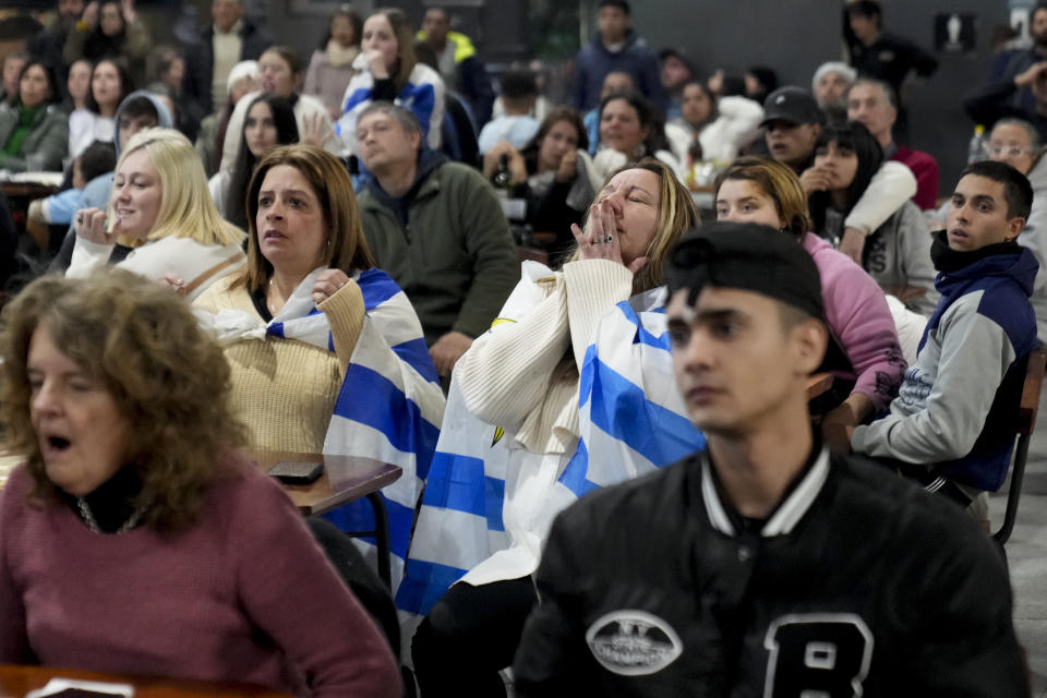 Fans react while watching a broadcast of the Copa America semifinal soccer match between Uruguay and Colombia in Montevideo, Uruguay, Wednesday, July 10, 2024. (AP Photo/Matilde Campodonico)