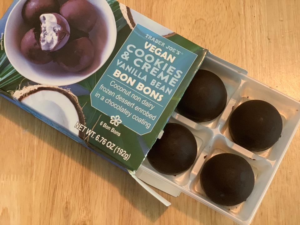 open blue and green box of trader joe's cookies and cream bonbons