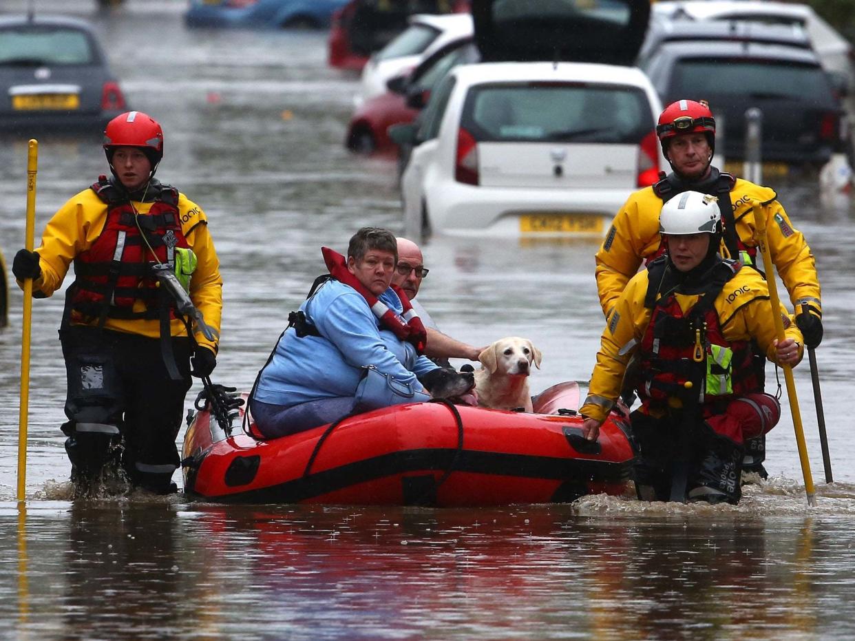 Residents and pets are evacuated from flooded homes in Nantgarw, South Wales: AFP via Getty