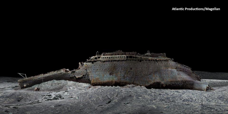 An image from a 3D scan of the Titanic showing the entire, ruined ship on the sea bed, viewed from the port side