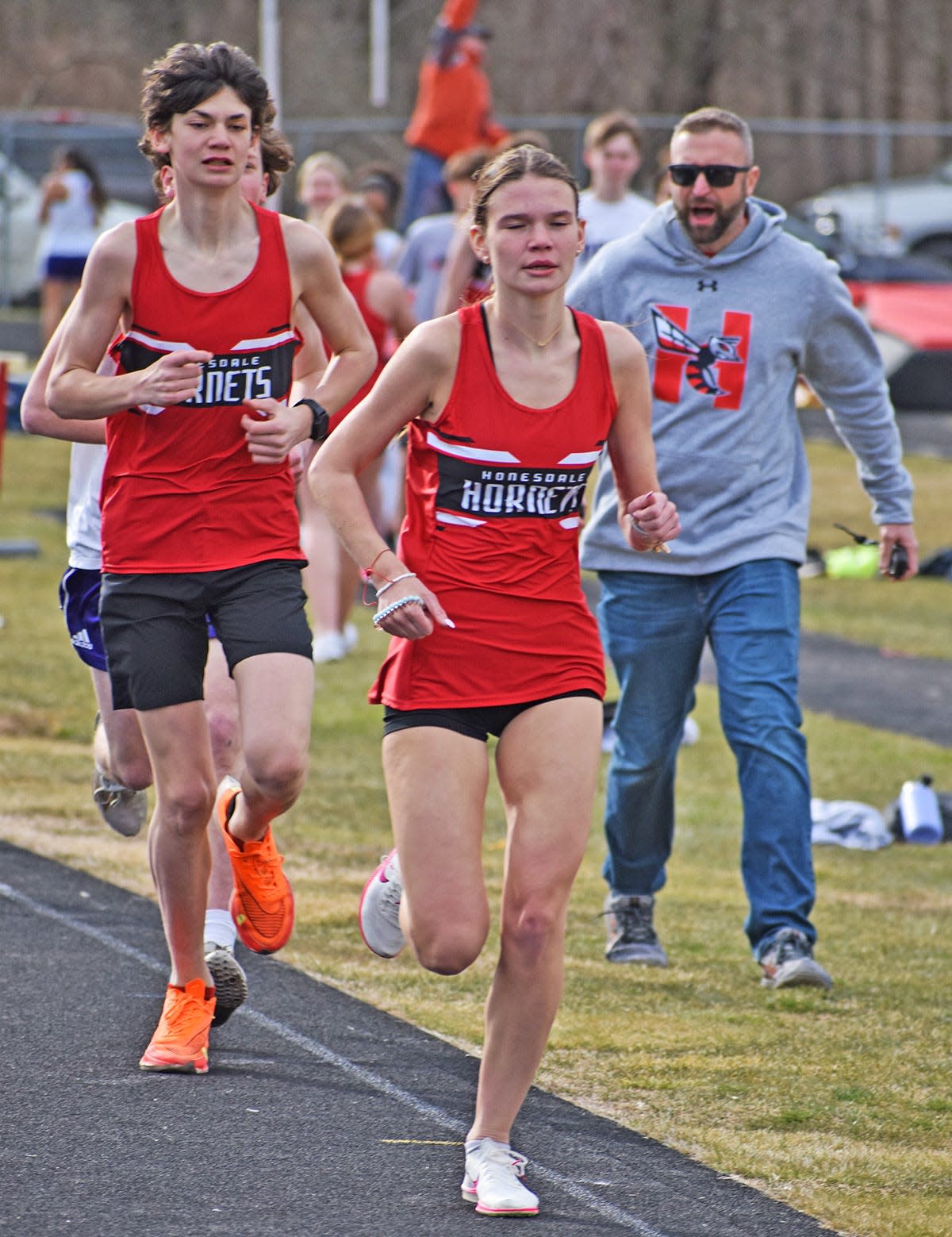 Brenna Dahlgren of Honesdale surges across the finish line to win the girls 1600M against Scranton Prep.