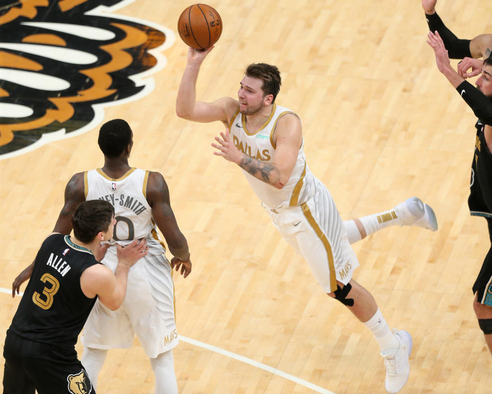 Dallas Mavericks guard Luka Doncic (77) shoots a three-point basket against the Memphis Grizzlies as time expired in the fourth quarter at FedExForum. Mandatory Credit: Nelson Chenault-USA TODAY Sports