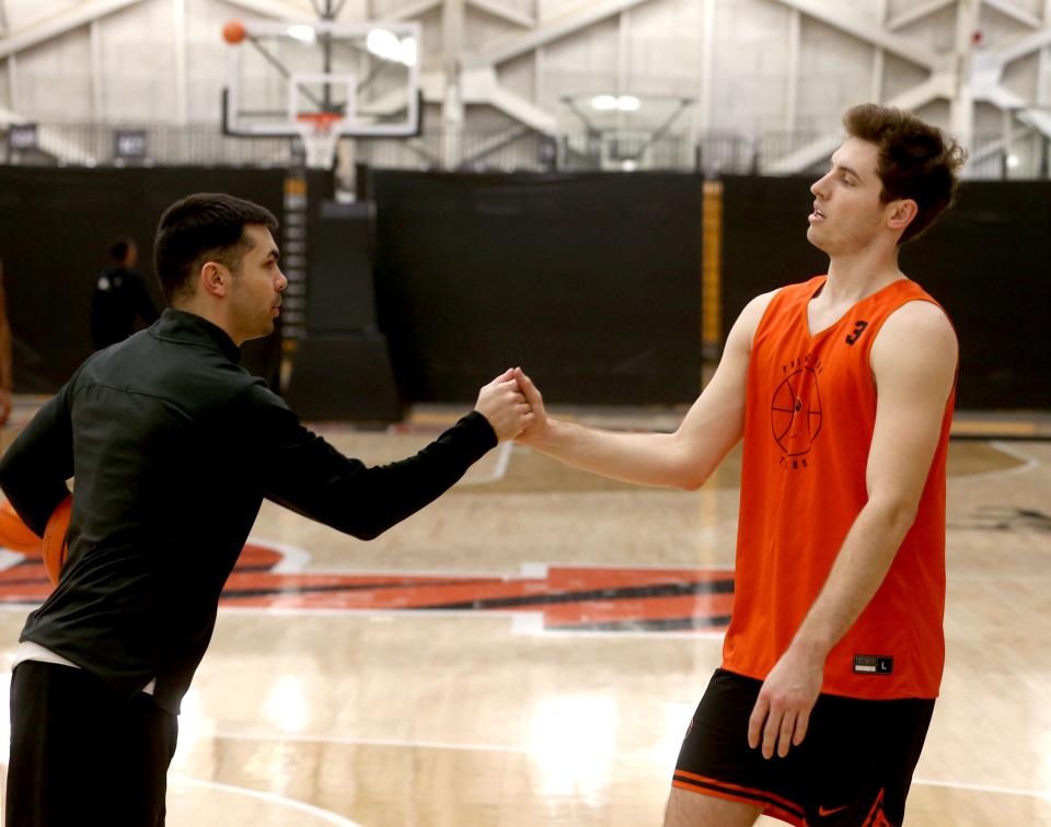 Princeton University associate head coach Brett MacConnell is shown with guard Ryan Langborg on the court at the University's Jadwin Gym Monday afternoon, March 20, 2023. The team was preparing for its NCAA Sweet 16 appearance.