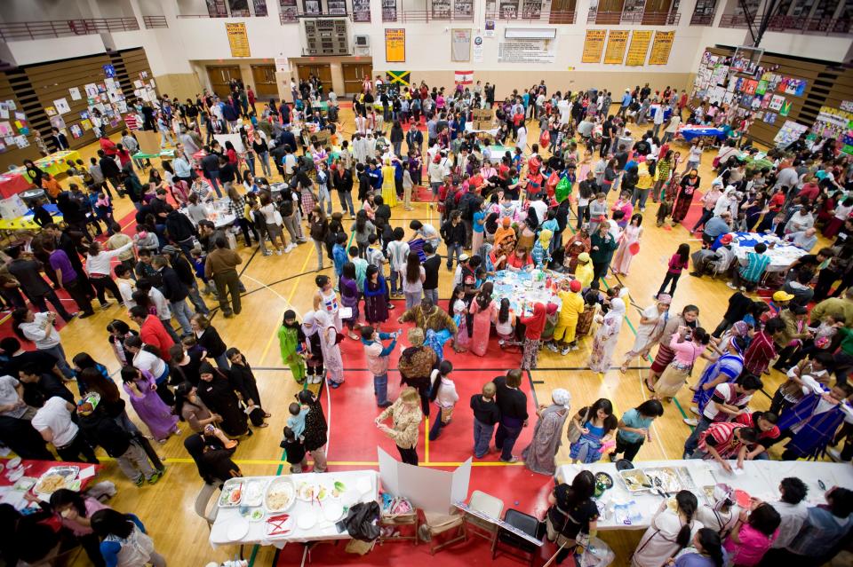 Students and visitors fill the floor of Proctor's gym for the school's annual International night, Thursday, March 18, 2010, in Utica.