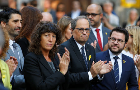 Catalan Regional President Quim Torra applauds along members of his cabinet during a flowers-laying ceremony on Catalonia's national day 'La Diada', in Barcelona, Spain, September 11, 2018. REUTERS/Enrique Calvo
