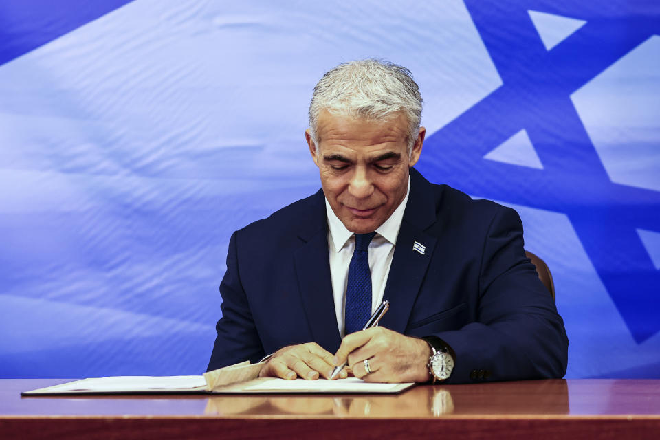 File - Israeli Prime Minister Yair Lapid signs a U.S.-brokered deal setting a maritime border between Israel and Lebanon, at the Prime Minister's office in Jerusalem, Thursday, Oct. 27, 2022. Lebanon signed and delivered its copy of a U.S.-mediated sea border deal with Israel on Thursday to a U.S. mediator, hoping to soon start exploring gas in its southern maritime blocs to bring economic stability to the crisis-ridden country. (Ronen Zvulun/Pool Photo via AP, File)