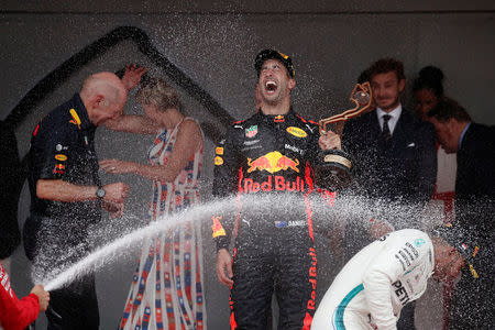 Formula One F1 - Monaco Grand Prix - Circuit de Monaco, Monte Carlo, Monaco - May 27, 2018 Red Bull’s Daniel Ricciardo celebrates winning the race with Lewis Hamilton who finished in third while Prince Albert II of Monaco and Charlene, Princess of Monaco look on REUTERS/Benoit Tessier