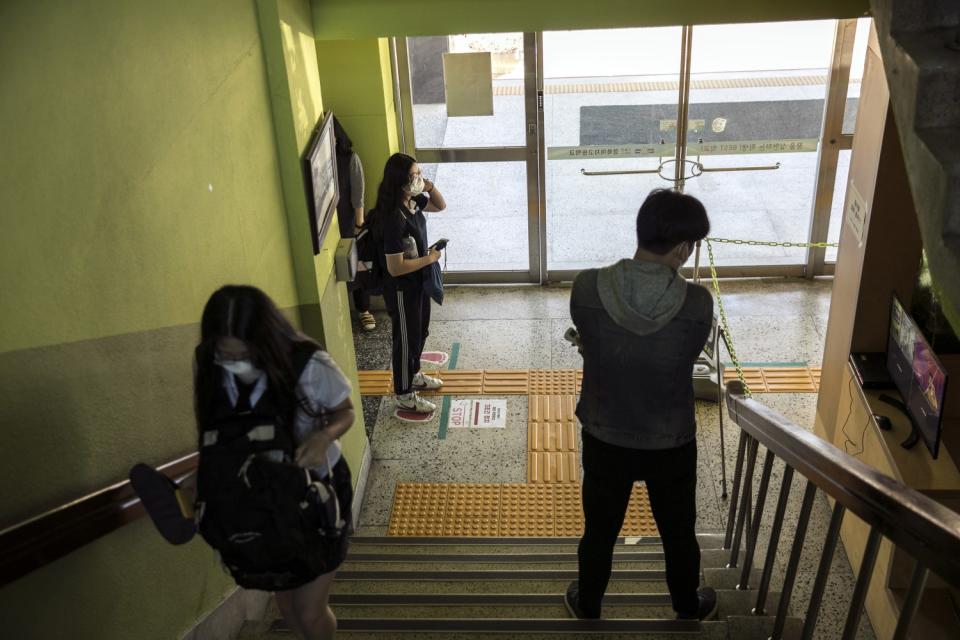 A student passes by a thermal imaging camera at the start of the school day at Gyungbuk Girls' High School, in Daegu, South Korea. Classes resumed on May 20, 2020.