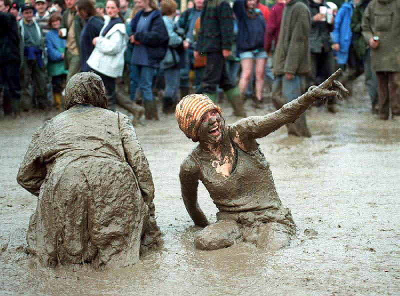 Festival-goers seems thrilled to be in the mud during Glastonbury 1997. (Jon Mills)