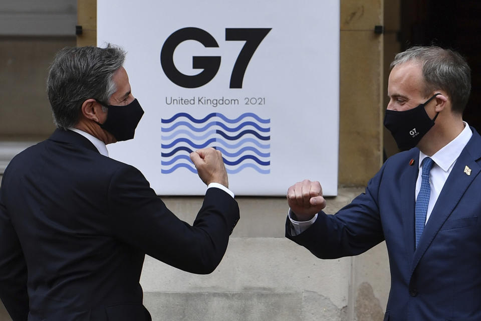 US Secretary of State Antony Blinken, left, is greeted by Britain's Foreign Secretary Dominic Raab at the start of the G7 foreign ministers meeting in London Tuesday May 4, 2021. G7 foreign ministers meet in London Tuesday for their first face-to-face talks in more than two years. (Ben Stansall / Pool via AP)