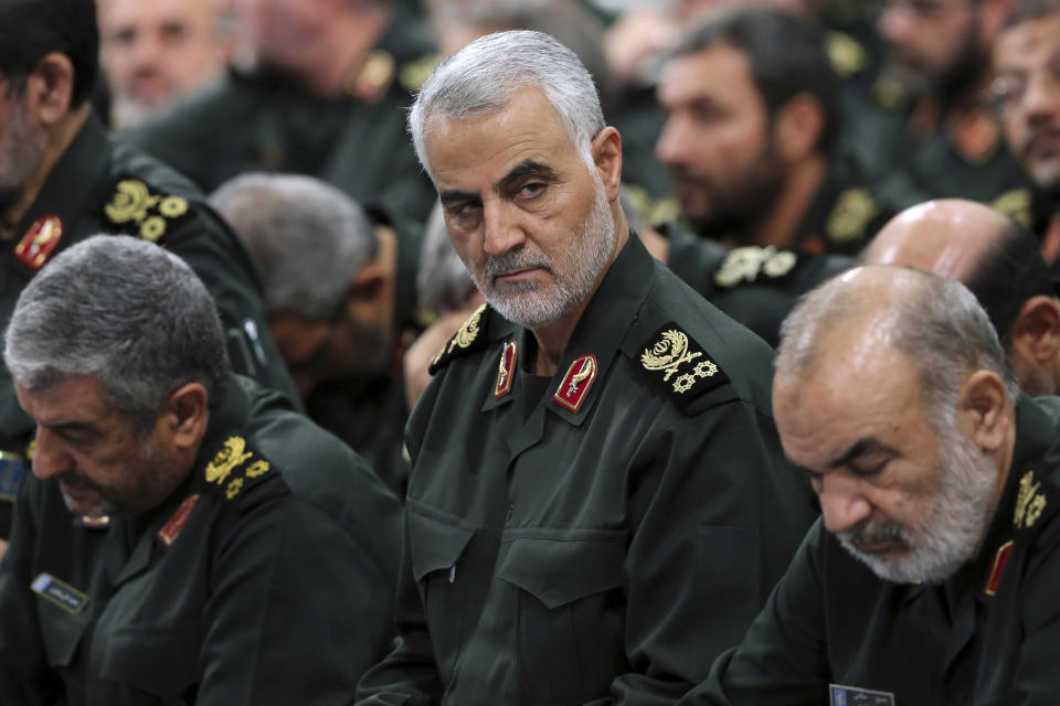 FILE- In this Sept. 18, 2016 photo released by an official website of the office of the Iranian supreme leader, Revolutionary Guard Gen. Qassem Soleimani, center, attends a meeting with Supreme Leader Ayatollah Ali Khamenei and Revolutionary Guard commanders in Tehran, Iran. Iran's paramilitary Revolutionary Guard faces new sanctions from U.S. President Donald Trump as he has declined to re-certify the nuclear deal between Tehran and world powers. But what is this organization? (Office of the Iranian Supreme Leader via AP, File)