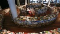 Visitors walk in a labyrinth installation made up of 250,000 books titled "aMAZEme" by Marcos Saboya and Gualter Pupo at the Royal Festival Hall in central London July 31, 2012.