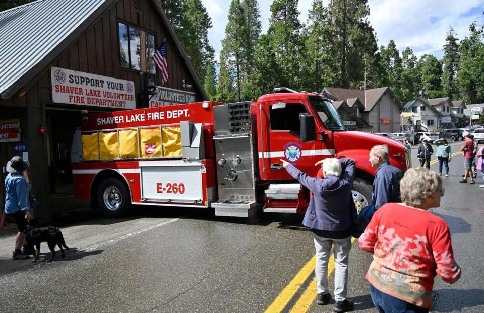 A crowd gathers on the closed road as Shaver Lake Volunteer FIre Department’s new fire engine E-260 is parked in front before the “push in” ceremony Thursday afternoon, Aug. 24, 2023 in Shaver Lake.
