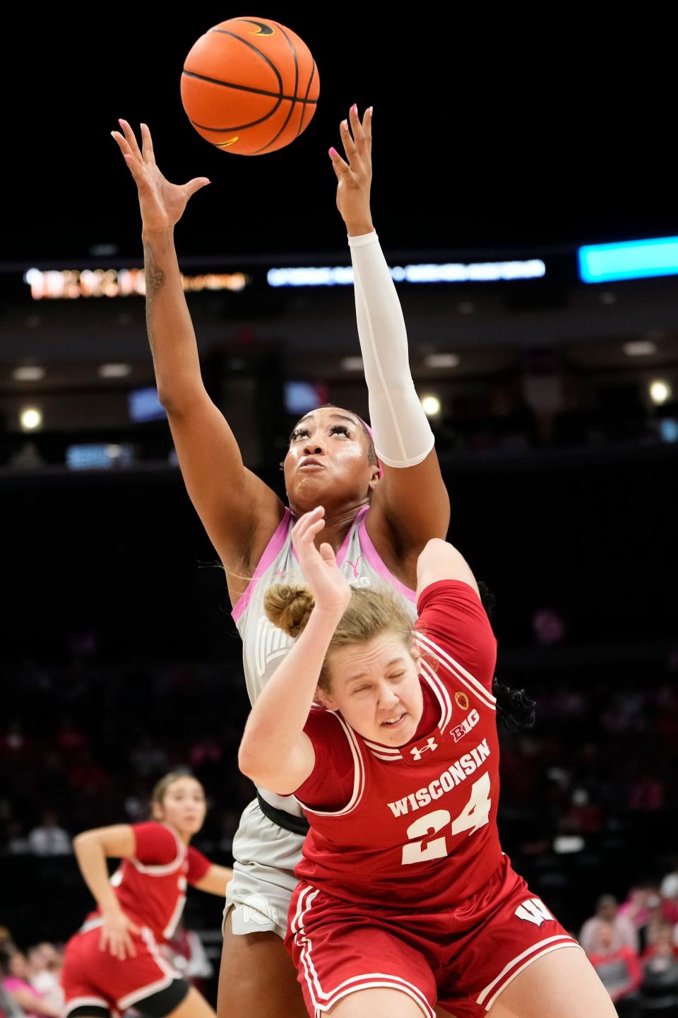 Feb 1, 2024; Columbus, OH, USA; Ohio State Buckeyes forward Cotie McMahon (32) grabs a rebound over Wisconsin Badgers guard Natalie Leuzinger (24) during the first half of the NCAA women’s basketball game at Value City Arena.