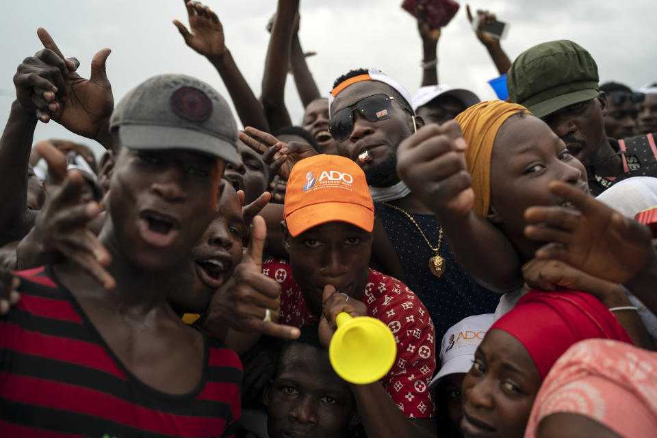 Supporters cheer for Ivory Coast President Alassane Ouattara before his arrival at a rally in Anyama, in the outskirts of Abidjan, Ivory Coast, Wednesday, Oct. 28, 2020. Ouattara, who first came to power after the 2010 disputed election whose aftermath left more than 3,000 people dead, is now seeking a third term in office. The candidate maintains that he can serve a third term because of changes to the country's constitution, though his opponents consider his candidacy illegal. (AP Photo/Leo Correa)