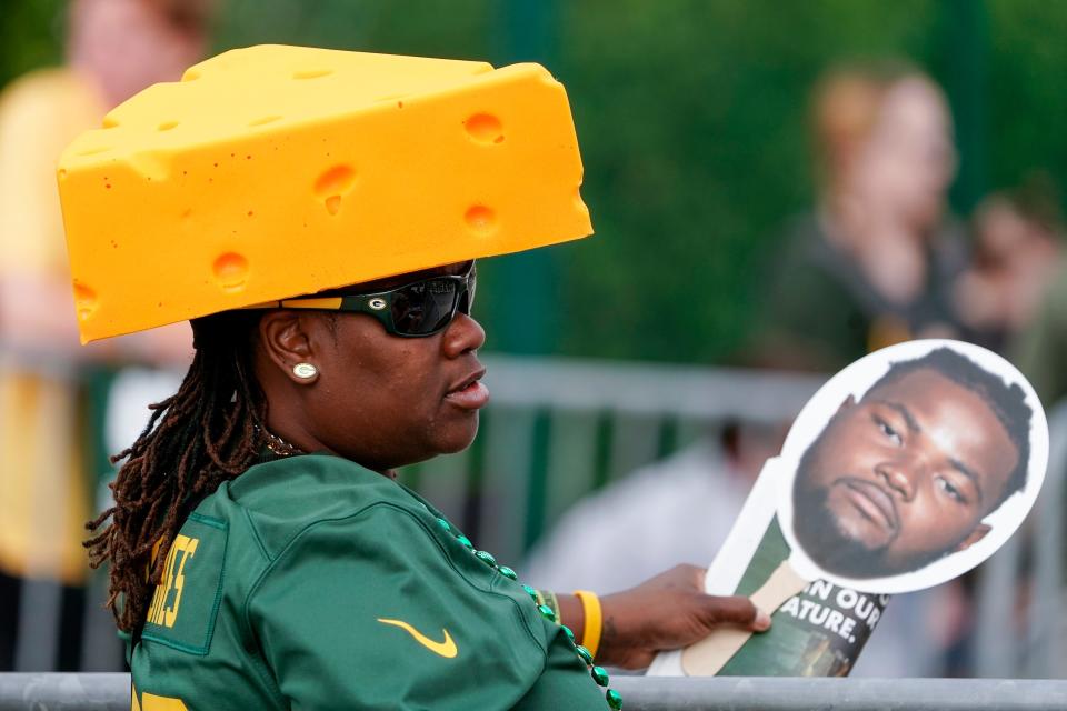 Green Bay Packers fan Tameka Tmith watches outside the NFL football team's practice field Wednesday, July 27, 2022, in Green Bay, Wis. (AP Photo/Morry Gash)