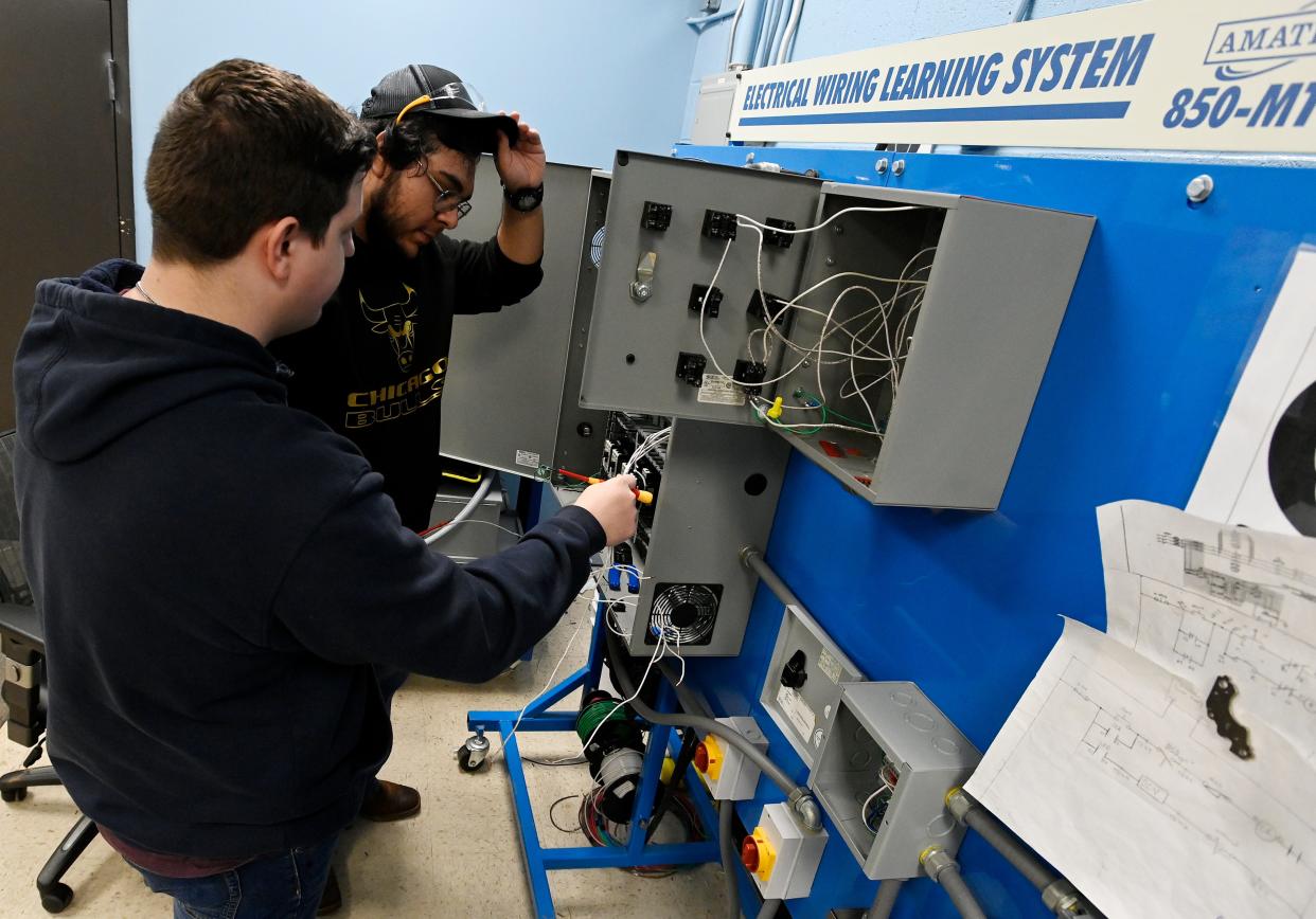 Brandon Roberson, 18, left, and Victor Marchan, 17, work together on an electrical wiring system during a class at the Tennessee College of Applied Technology.