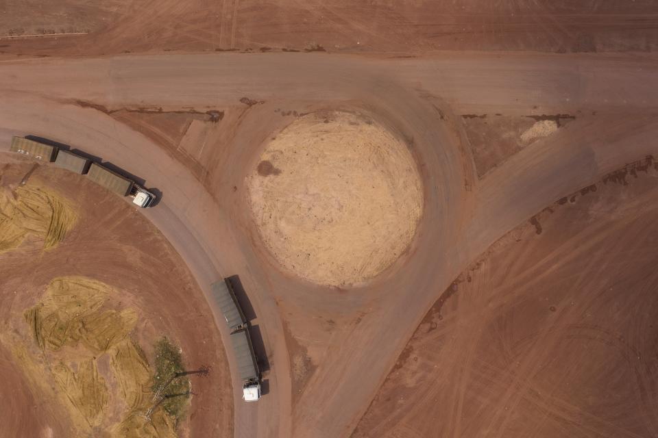 FILE - Cargo trucks turn off the Trans-Amazon highway, top, onto route BR-163 in Campo Verde, near Itaituba, Para state, Brazil, Nov. 29, 2019. (AP Photo/Leo Correa, File)