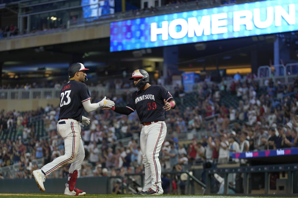 Minnesota Twins' Royce Lewis (23) celebrates with Donovan Solano after hitting a two-run home run against the Cleveland Guardians during the eighth inning of a baseball game Thursday, June 1, 2023, in Minneapolis. (AP Photo/Abbie Parr)