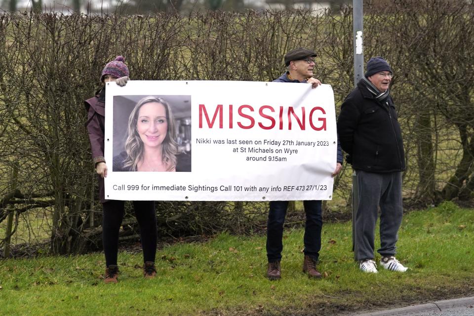 Members of the public line the road into St Michael’s on Wyre, Lancashire, with missing posters of Nicola Bulley (Danny Lawson/PA) (PA Wire)