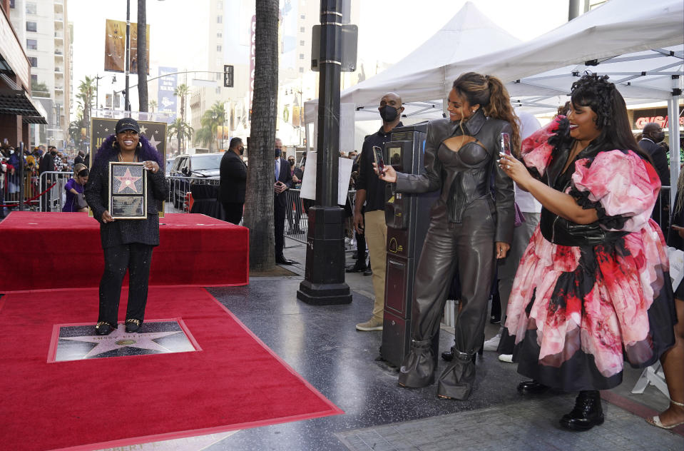 Singers Lizzo, far right, and Ciara, second from right, take pictures of hip hop artist Missy Elliott during a ceremony to award her a star on the Hollywood Walk of Fame, Monday, Nov. 8, 2021, in Los Angeles. (AP Photo/Chris Pizzello)