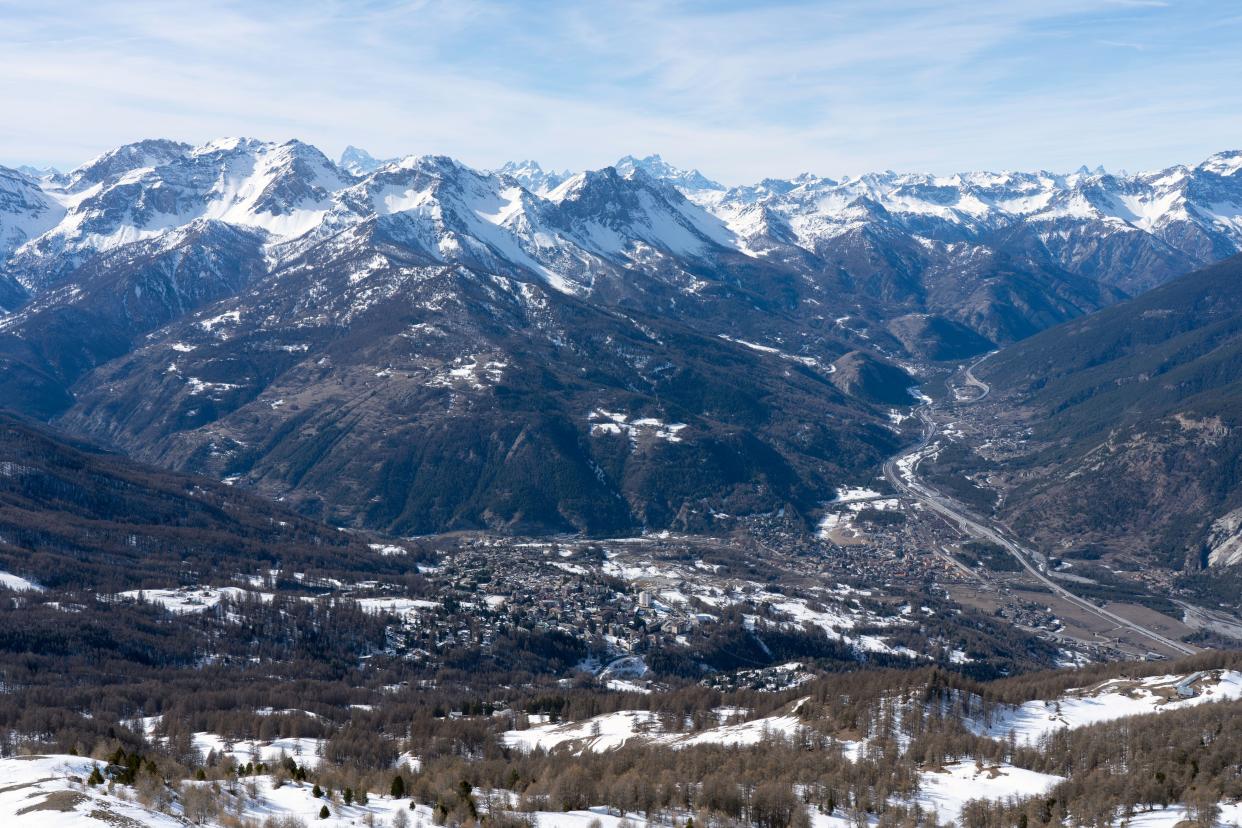 view of Oulx city in the mountains (Susa Valley, Piedmont, Italian Alps) in winter with snow.