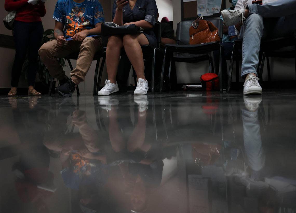 About 40 people wait in the lobby inside Catholic Charities legal services on Monday, Jan. 9, 2023, in downtown Miami.