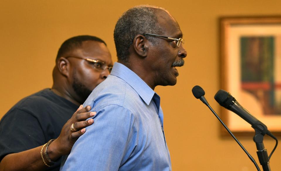 Leshumbai "Shuma" Stokes, oldest son of Crosley Green, comforts his father as he became emothonal while speaking at the Sept. 26 press conference at the Holiday Inn in Titusville, regarding the recent U.S. Court of Appeals for the 11th Circuit denying his request for a rehearing. 