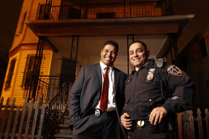 Oscar Perez, right, now deputy chief of the Providence Police Department, was a lieutenant when he was photographed here outside his childhood home on Elma Street with his brother, Detective Andres Perez.